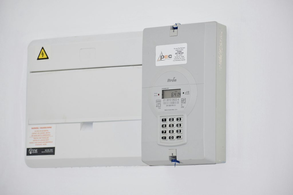 pexels-photo-13785838-13785838 Electrical meter and fuse box on a white wall in Cape Town, South Africa, for energy monitoring or billing.